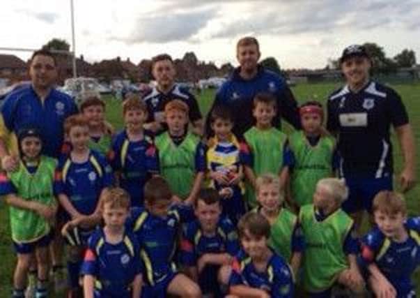 Chris Hemmings (back, second from right) with Bentley Under-8s players and Dons stars Kieran Cross and Jordie Hedges.