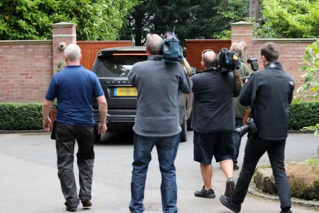A car goes through the gates of the home of former England captain Wayne Rooney in Prestbury, Cheshire after he was charged with drink driving, Cheshire Police said.