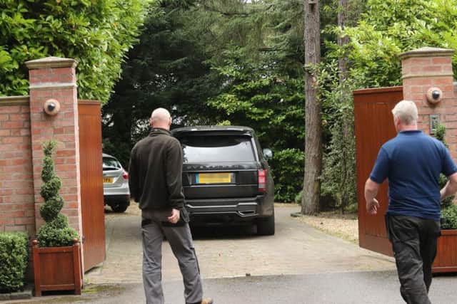 A car goes through the gates of the home of former England captain Wayne Rooney in Prestbury, Cheshire after he was charged with drink driving, Cheshire Police said.
