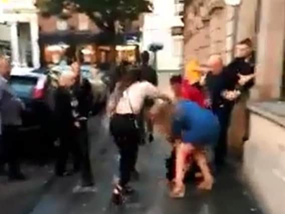 Women fight in the street outside the Coach and Horses in Scot Lane. (Photo: Scott Harrison).