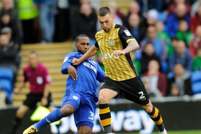 Jack Hunt tries to knock the ball past Cardiff forward Junior Hoilett