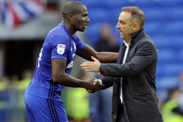 Carlos Carvalhal shakes hands with Cardiff scorer Sol Bamba