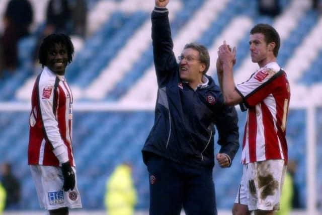 Sheffield United's manager Neil Warnock (C) celebrates at full time with goal scorers Ade Akinbiyi (L) and Michael Tonge after victory at Hillsborough in 2006