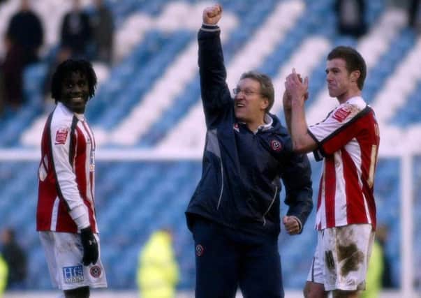 Sheffield United's manager Neil Warnock (C) celebrates at full time with goal scorers Ade Akinbiyi (L) and Michael Tonge after victory at Hillsborough in 2006