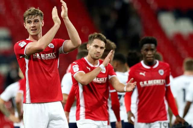 Barnsley's Liam Lindsay (left) acknowledges the fans after the final whistle at Tottenham