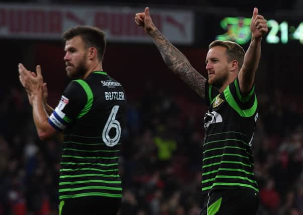 Andy Butler and James Coppinger salute the 5,000 travelling Rovers fans at Arsenal.