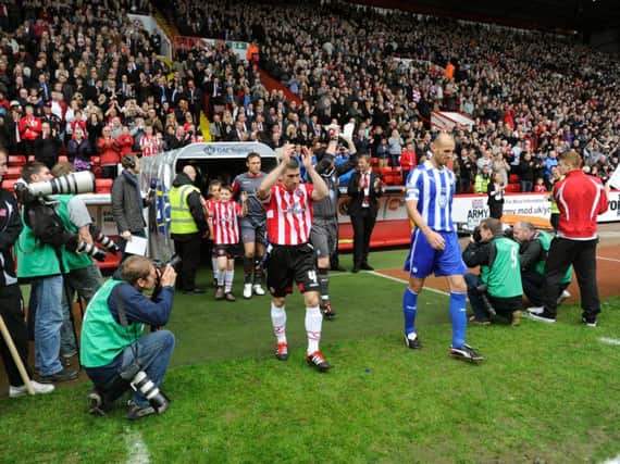 Nick Montgomery and Rob Jones lead out the teams at Bramall Lane in 2011
