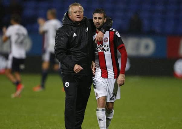 Chris Wilder comes off the pitch with Danny Lafferty after the 1-0 win over Bolton Wanderers