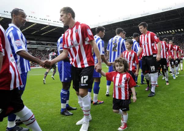 Richard Cresswell shakes hands with Chris O'Grady before the STeel City derby in Blades colours