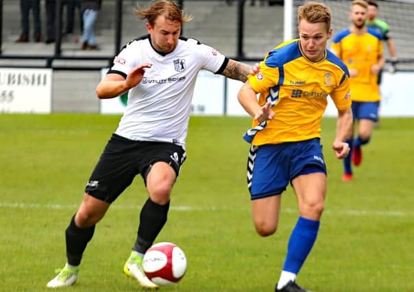 Stocksbridge PS midfielder Jack Poulter, right,  battles for possession in Steels 2-1 defeat at Corby Town. Photo: Ian Revitt