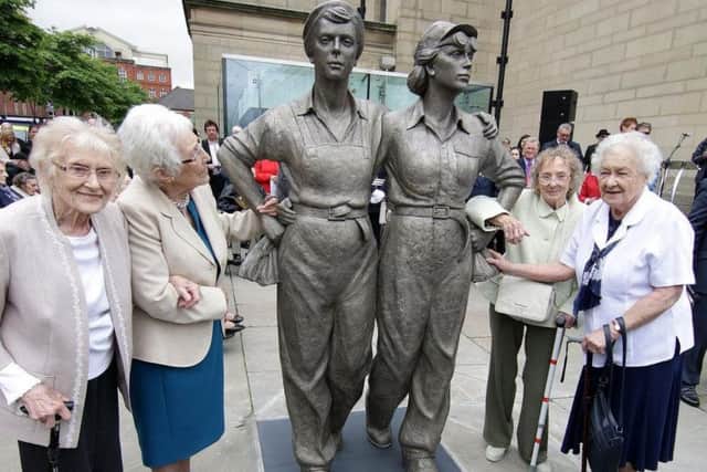 Women Of Steel survivors with their statue in Barker's Pool outside Sheffield City Hall.