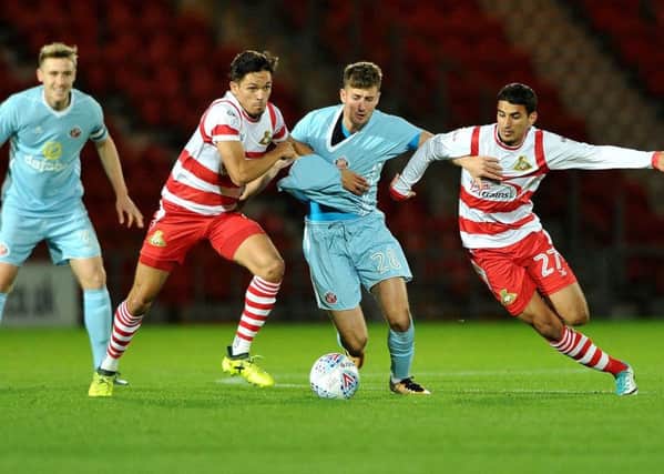 Niall Mason, left, and Issam Ben Kemis try to dispossess Sunderland's Ethan Robson. Picture: Frank Reid