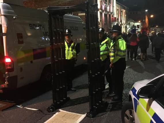 Police use a metal detector to search people for knives in Carver Street. Photo: Sheffield central neighbourhood policing team.