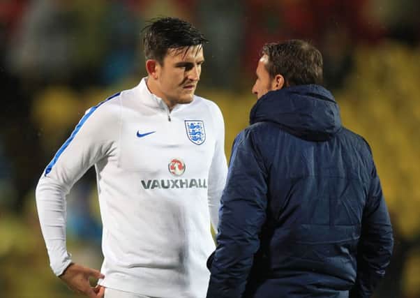 Harry Maguire speaks with England manager Gareth Southgate ahead of his first cap for his country