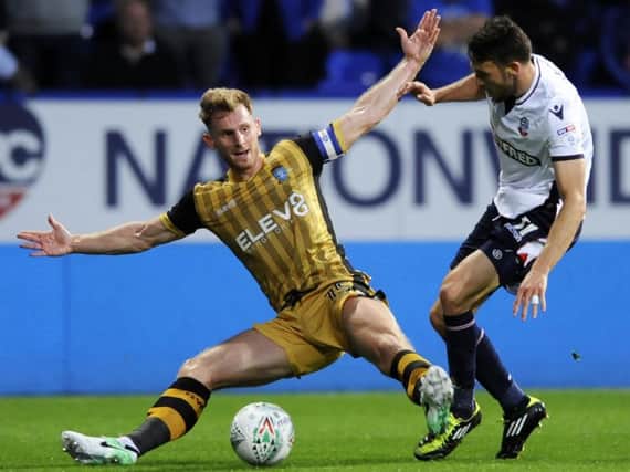 Tom Lees attempts to close down former Owl Will Buckley in Wednesday's cup defeat to Bolton