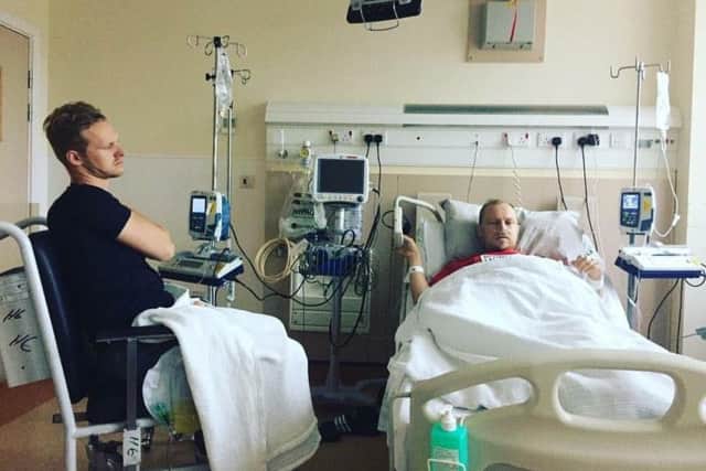 Sam undergoing dialysis, with his brother Josh by his bed