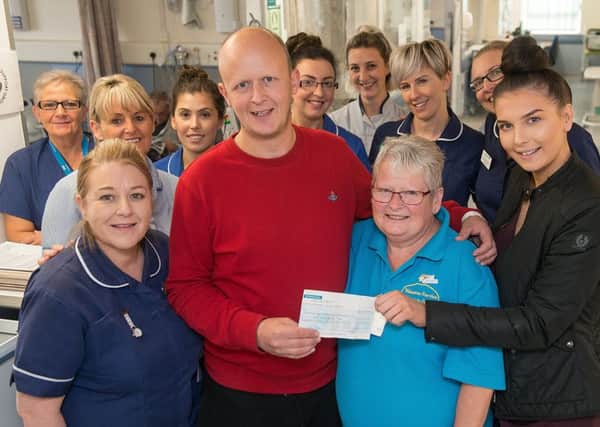 Cancer patient Steven Bryan with staff at Rotherham Hospital. He has raised over Â£1K to thank them for the support they gave him while he was undergoing treatment there.