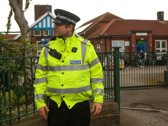 A police officer stands outside Long Toft Primary School, in Doncaster, South Yorks, where three children were run over and injured. A five year old boy and a two year old girl suffered minor injuries but a nine year old girl was airlifted to hospital. October 13, 2017. Three children have been injured - one seriously - after they were struck by a car at a school this morning (October 13). Two of the children - a five-year-old boy and a two-year-old girl - suffered minor injuries but a nine-year-old girl was airlifted to hospital. The extent of her injuries are not yet known. South Yorkshire Police said the car was "performing a manoeuvre" at the time of the collision at Long Toft Primary School in Doncaster, South Yorks. Picture: Benjamin Paul/SWNS