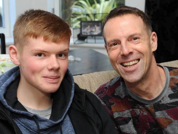 All smiles: Hero Herbie with dad Nigel. The 15-year-old saved his dad's life when he performed CPR on him after he suffered a heart attack at their Mosborough home. Picture: Andy Roe/The Star