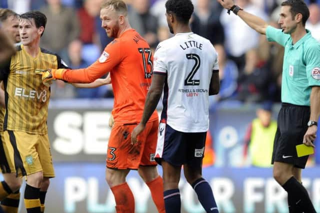 A knowing smile from Bolton keeper Ben Alnwick tells the story as Kieran Lee is booked for diving when he should have been awarded a penalty