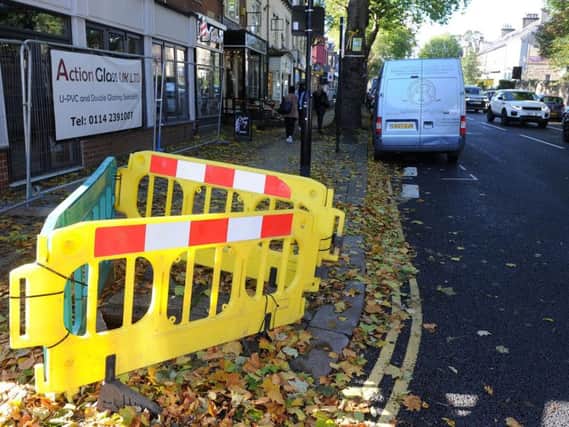Barriers around the manhole cover in Ecclesall Road.