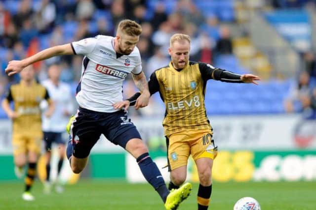 Barry Bannan is challenged by former Owl Mark Beevers at Bolton