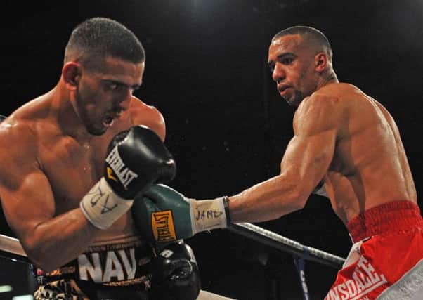 Tyan Booth (right) fighting Rotherham's Nav Mansouri