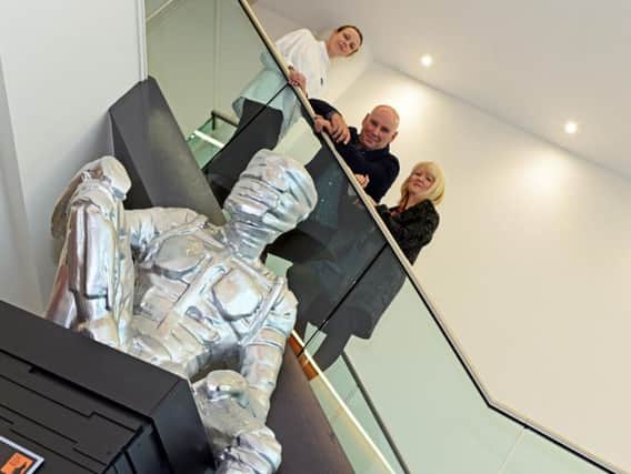 Martha McGuinn, Steve Mehdi and Jane Hughes, pictured, by a model of The Steel Man. Picture: Marie Caley