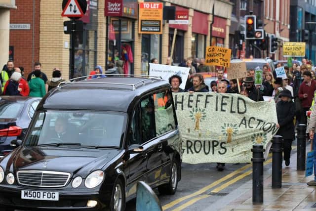 A hearse leads the funeral process through Sheffield city centre (photo: Chris Etchells)