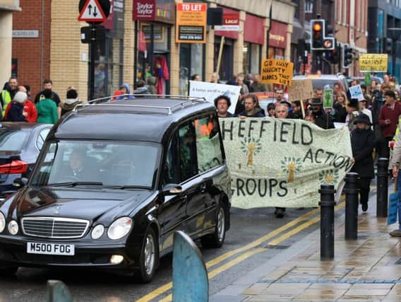 A hearse leads the funeral process through Sheffield city centre (photo: Chris Etchells)