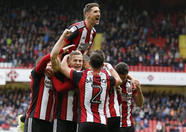 Celebration time as the Blades take the lead. Pictures: Simon Bellis/Sport Image