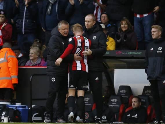 Chris Wilder gives Mark Duffy a hug during the Blades' match against Reading on Saturday