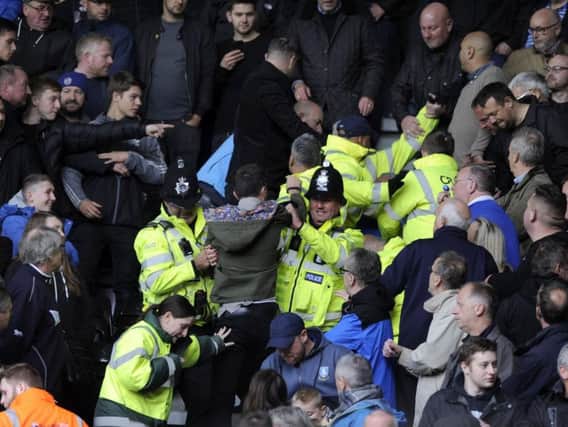 Police and stewards had to restrain fans after fighting broke out within the Sheffield Wednesday section of the stands