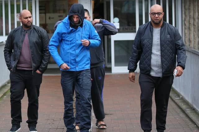 Amjal Rafiq, 38 (blue coat) and Aftab Hussain, 38 (far right) leave Sheffield Magistrates' Court. Picture: Tom Maddick
