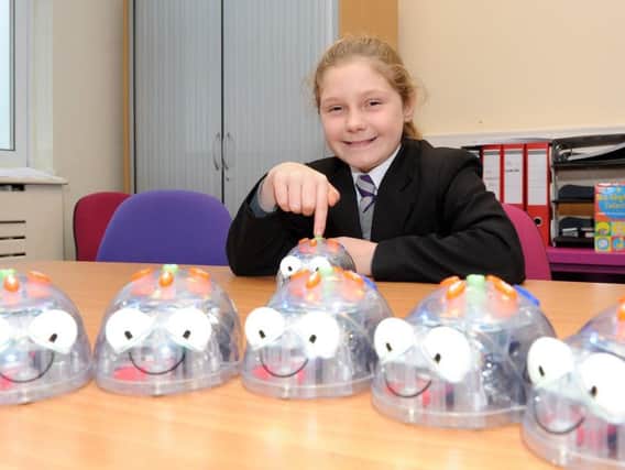 Pupil Angel Lowe programs a robot to move which is part of the school STEM activities