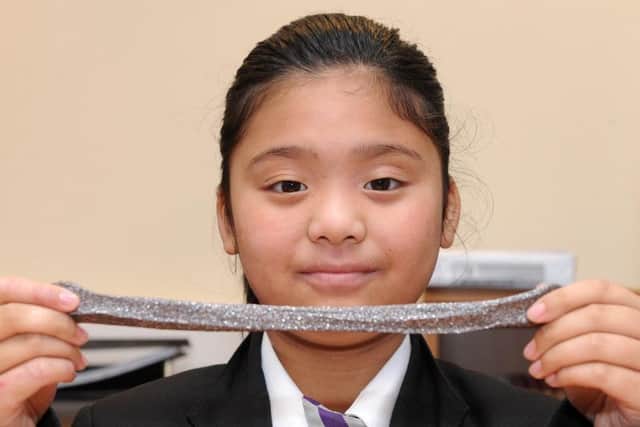 Isabella Htoo stretches her slime she made as part of the school's STEM activities