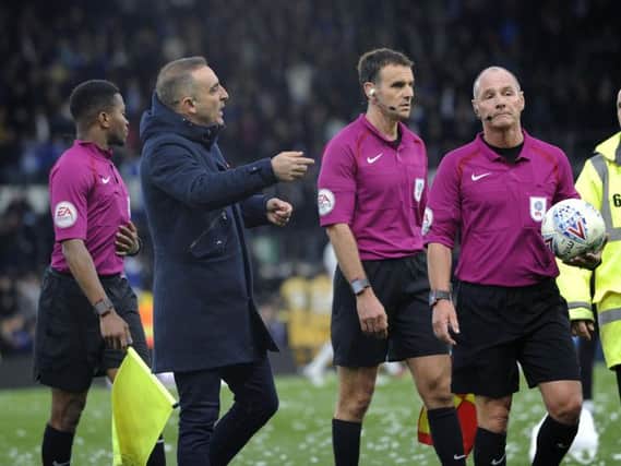 Carlos Carvalhal has a word with referee Scott Dunan after the defeat to Derby County