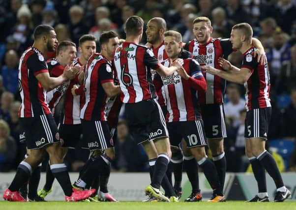 United celebrate with Billy Sharp after he opened the scoring