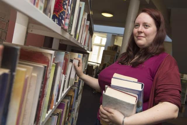 Emma Carpenter organising the library shelves. Picture: Dean Atkins