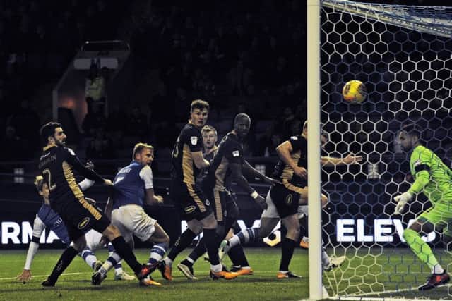 Jordan Rhodes watches as his header finds the net for what proved the decisive goal in Sheffield Wednesdays 2-1 home victory over Millwall last night (Picture: Steve Ellis).