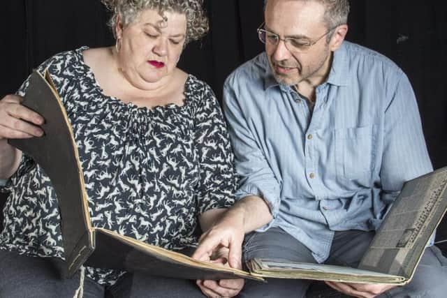 Viv Mager and Kevin Jackson leaf through the Dilys Guite Players' archive books. Picture: Dean Atkins