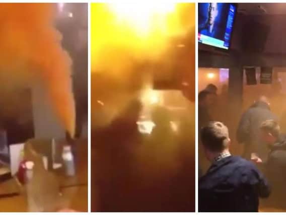 Hull City fans let off a smoke bomb in a Sheffield pub. Videos tweeted by @TheAwayFansVids and @hullcityprotest