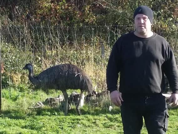 Ted Phillips pictured with the emu he wrestled to the ground