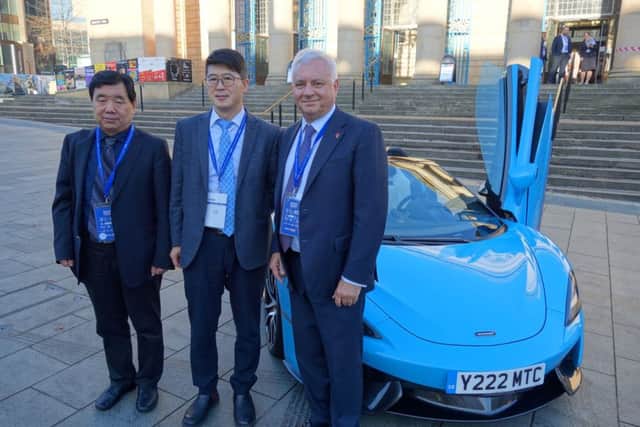 Sir Nigel Knowles, SheffCityRegion LEP chair, with Chinese delegates Yuan Haike, left, Kaiyu Zhang at SheffCityHall and a McLarenAuto 570s.