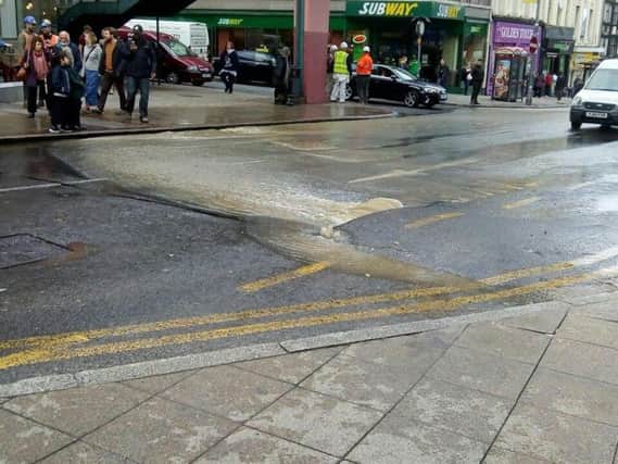Water began gushing from a crack in the road on Saturday