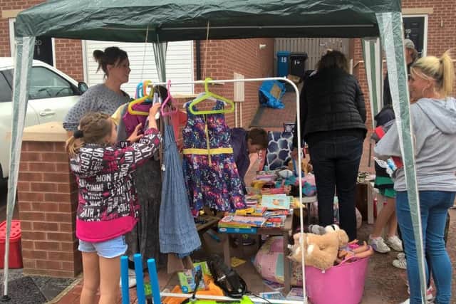 Ruby Fowler, eight, selling items at the jumble sale