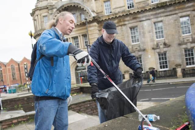 Volunteer litter-pickers help clean up the streets around the Old Town Hall on Saturday