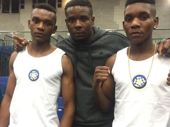 Levi, left, with his boxing brothers