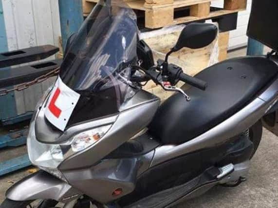 Police officers are searching for a stolen moped