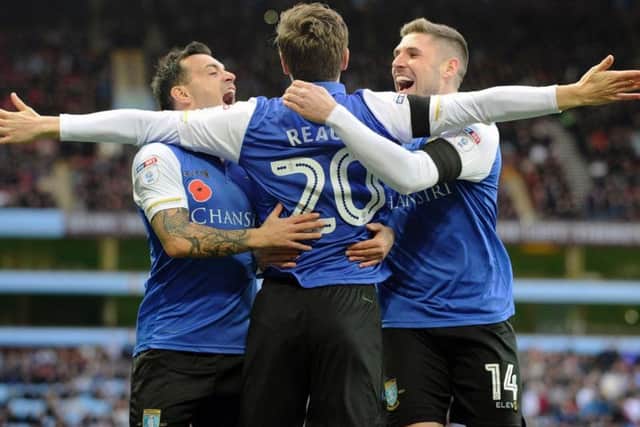 Ross Wallace and Gary Hooper celebrate with Adam Reach after the Owls winger's superb opener against Aston Villa